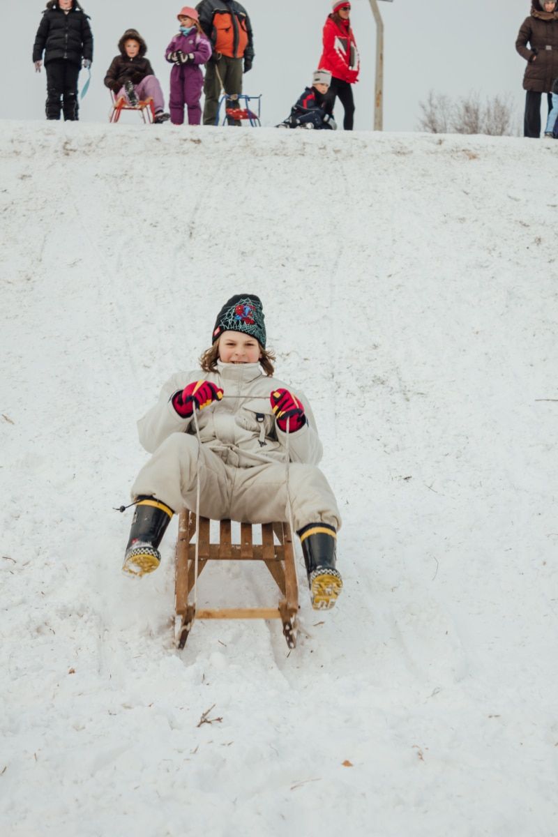 Children Sledding Down Hills