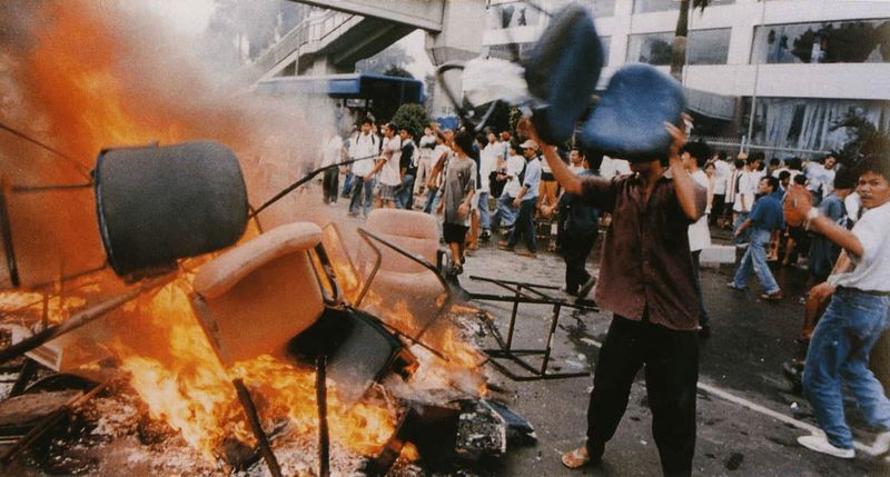 Shops owned by ethnic Chinese are looted and goods burned on the streets in Jakarta, Indonesia. May 14 1998