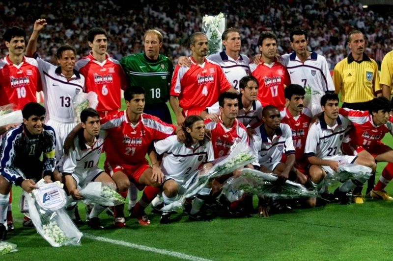 Iran vs USA soccer teams pose together pre-match
